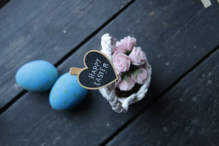 happy easter concept, basket of flowers and letteringの写真素材
