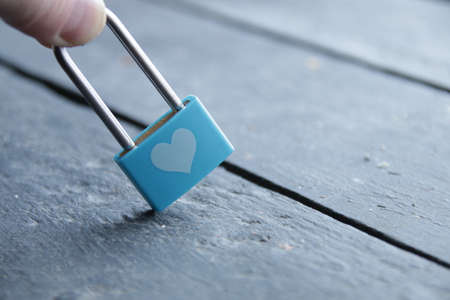 Love or Valentine's day idea. Blue padlock with heart on vintage background.の写真素材