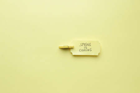 Creative concept Spring is coming.The inscription on a yellow label.の写真素材