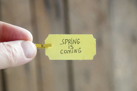 Creative concept Spring is coming.The inscription on a yellow label.の写真素材