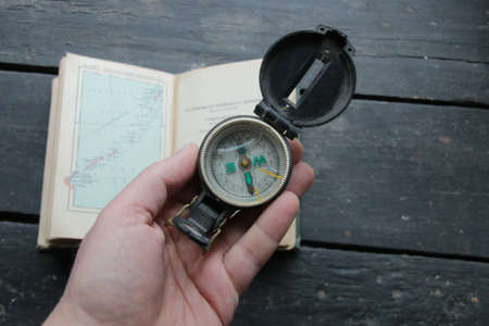Compass, navigational compass, travel concept on vintage map backgroundの写真素材
