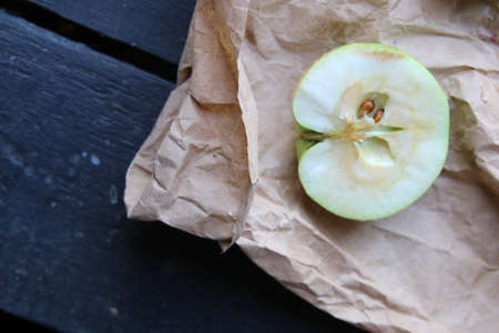 Half an apple on a vintage table. Food background.の写真素材