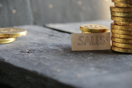 sales growth concept with golden coins moneyの写真素材