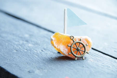 Summer vacation creative concept. Orange slice and sail.の写真素材