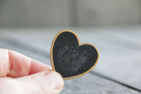 Valentine's day concept. Hand holds a heart-shaped tablet. Place for text.の写真素材