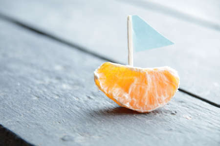 Summer vacation creative concept. Orange slice and sail.の写真素材