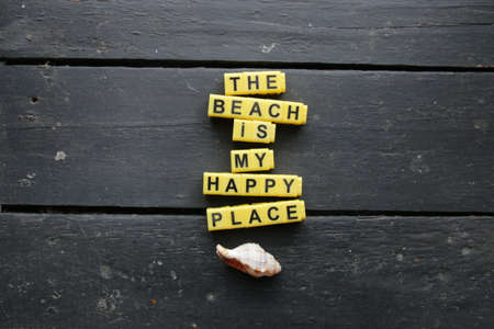 The beach is my happy place. Lettering on a vintage table.の写真素材