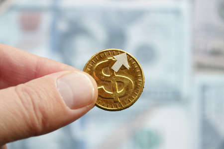 Income growth idea. Gold Dolar with an up arrow.の写真素材
