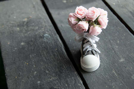 Flowers, background. A beautiful bouquet of flowers and one sneaker.の写真素材