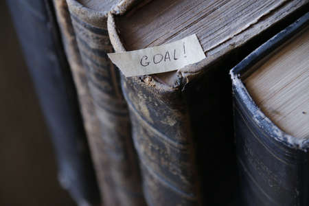 Goal, motivational concept. The inscription on the tag and retro books.の写真素材