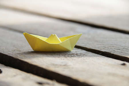 Yellow paper boat. Summer vacation idea.の写真素材