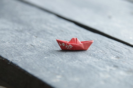 Paper boat with the inscription love, romantic background.の写真素材