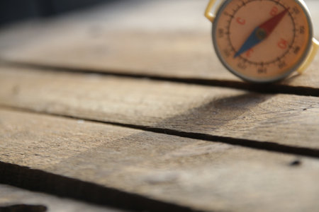 Compass on the vintage wooden table backgroundの写真素材