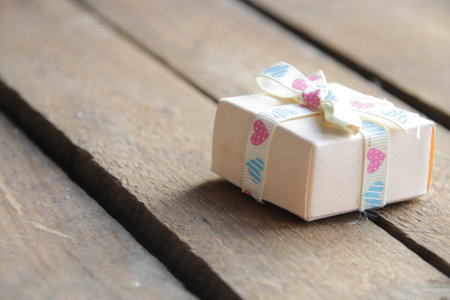 Gift with a ribbon on a beautiful wooden vintage background.の写真素材