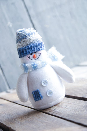 Friendly snowman on a vintage background. Cute Christmas toy.の写真素材