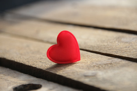 Red heart on a wooden background. Place for text. Valentines card.の写真素材