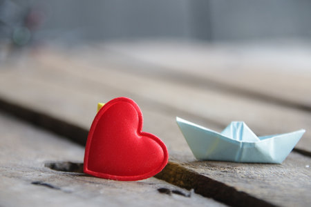 Red heart on a wooden background. Place for text. Valentines card.の写真素材