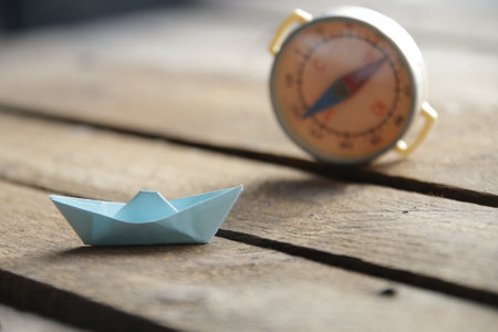 Beautiful paper boat on a vintage wooden background.の写真素材