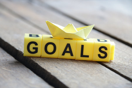 Goals concept. The inscription from the yellow cubes. On a wooden background.の写真素材