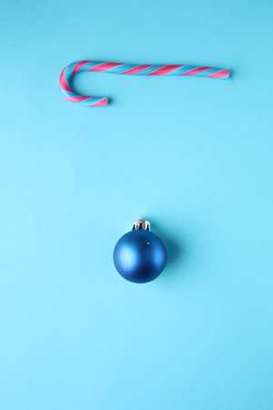 Merry christmas creative card. Candy cane and Christmas Bauble.の写真素材
