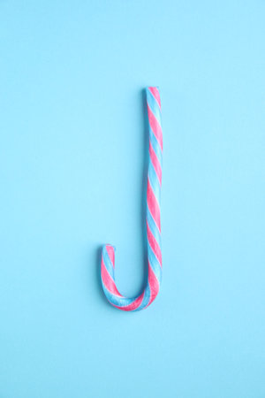 Merry christmas creative card. Candy cane on a blue background.の写真素材