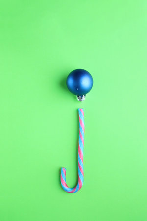 Merry christmas creative card. Candy cane and Christmas Bauble.の写真素材