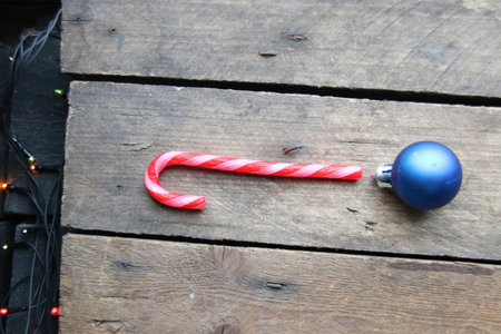 Merry Christmas creative card. Candy cane on a wooden background.の写真素材