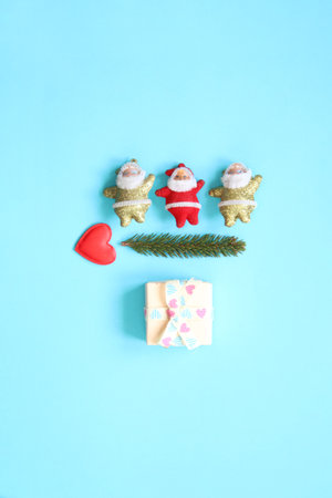 Merry Christmas creative concept. Three Santa Clauses and a spruce branch.の写真素材