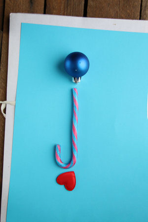 Merry christmas creative card. Candy cane on a blue background.の写真素材