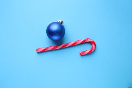 Merry christmas creative card. Candy cane on a blue background.の写真素材