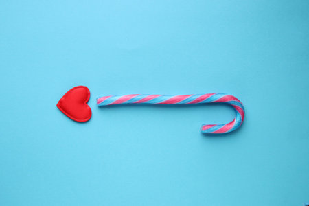 Merry christmas creative card. Candy cane on a blue background.の写真素材