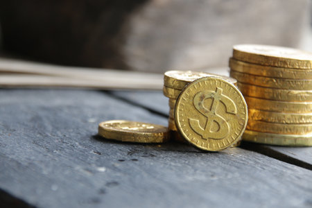 Coin stacks on a gray wooden background.の写真素材