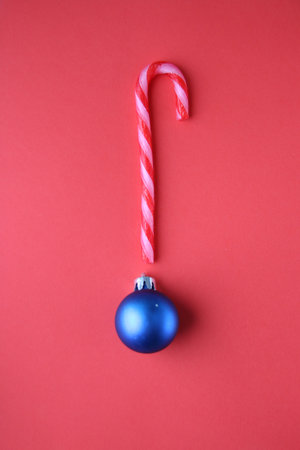 Christmas candy cane on a red background.の写真素材