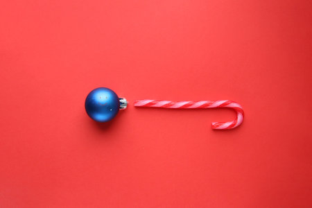 Merry christmas card. Christmas candy cane on a red background.の写真素材