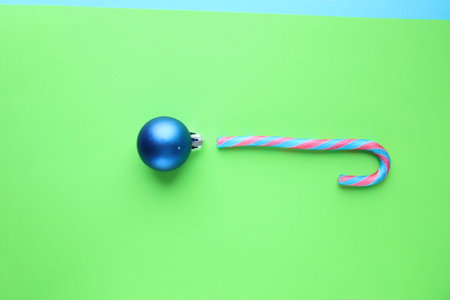 Merry christmas creative card. Candy cane and Christmas Bauble.の写真素材