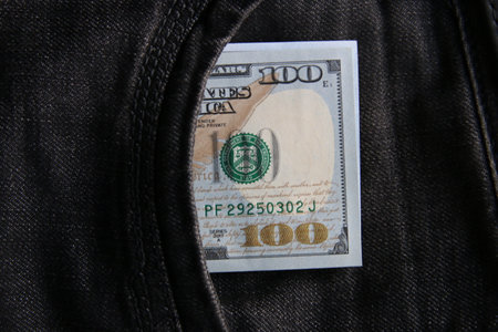 Dollars in a jeans pocket, closeup.の写真素材