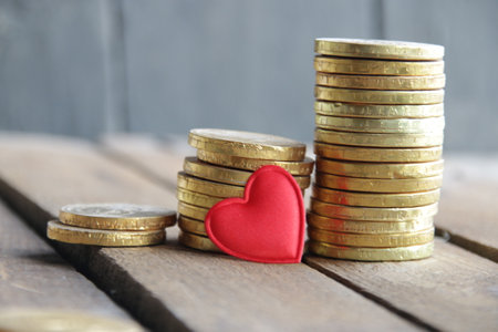 Business graph made of coins on a wooden background.の写真素材
