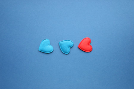 Three hearts on a blue background