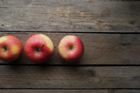 Ripe juicy apples on a vintage wooden background.の写真素材