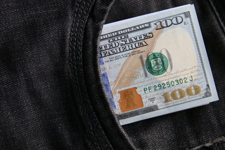 Dollars in a jeans pocket, closeup.の写真素材