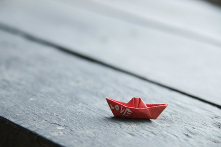 Paper boat with the inscription love, romantic background.の写真素材