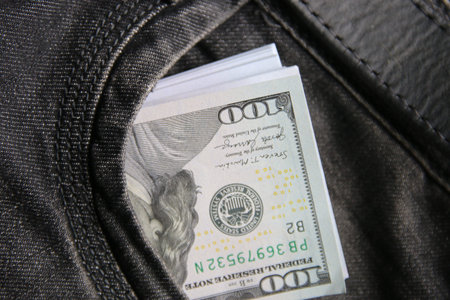 American dollars USD banknotes in jeans pocket.