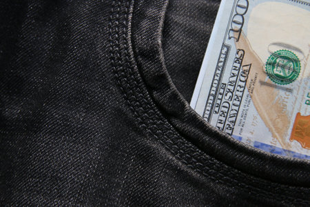 Dollars in a jeans pocket, closeup.の写真素材