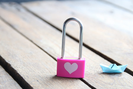 Pink padlock with a heart. Creative romantic background.の写真素材