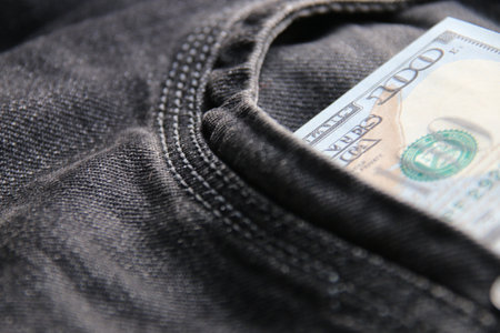 Dollars in a jeans pocket, closeup.の写真素材
