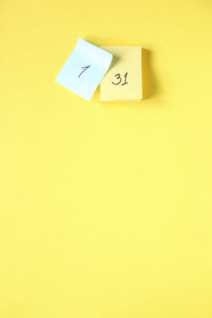 The number 1 and 31 in the calendar. Calendar pages on a yellow background.の写真素材