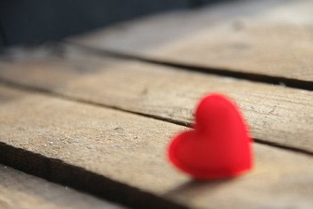 Red heart on a wooden background. Place for text. Valentines card.の写真素材