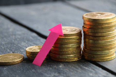 Income growth. Creative concept with Red arrow and golden coins. money. interest rate and dividend concept.の写真素材