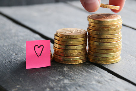 Income growth. Creative concept with golden coins. A man rising coins.の写真素材