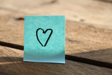 Heart on a blue paper tag. Birthday background.の写真素材